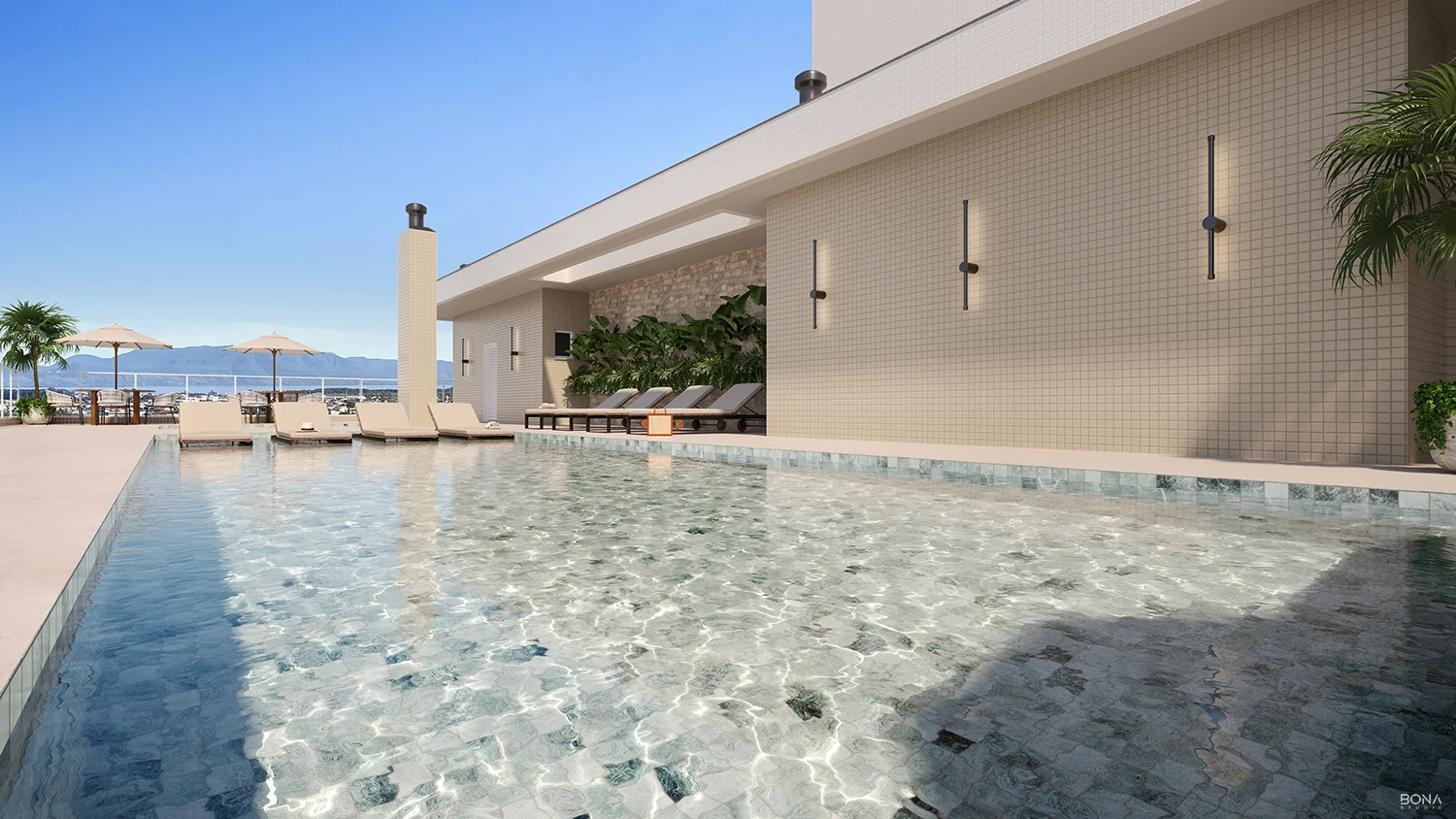Piscina adulto aquecida no rooftop do Altavista Ubirajara, com deck, espreguiçadeiras e guarda-sóis