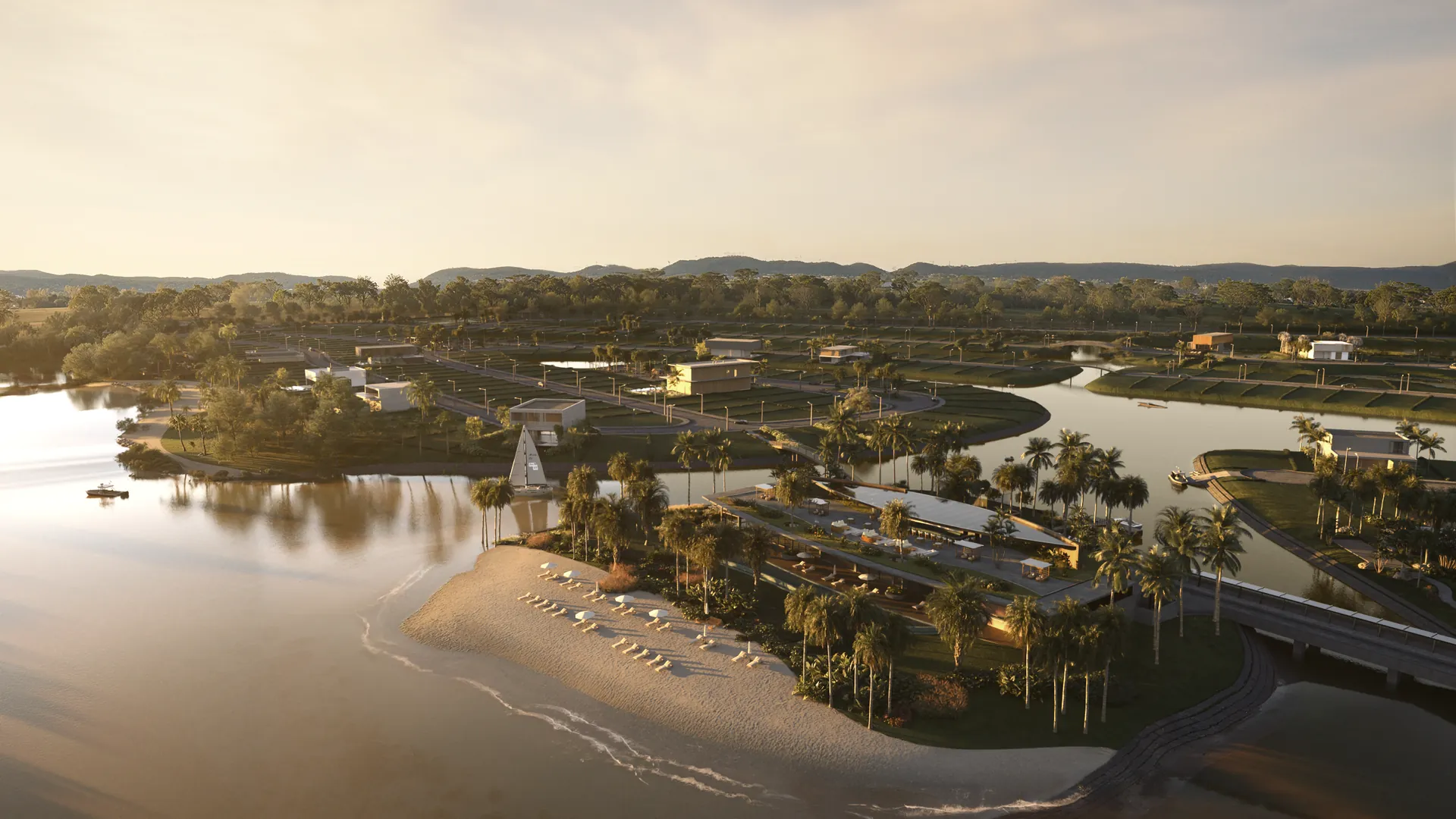 Vista aérea do clube junto à praia e aos lagos ao entardecer dourado, Brávia Marina & Beach Club em Maquiné