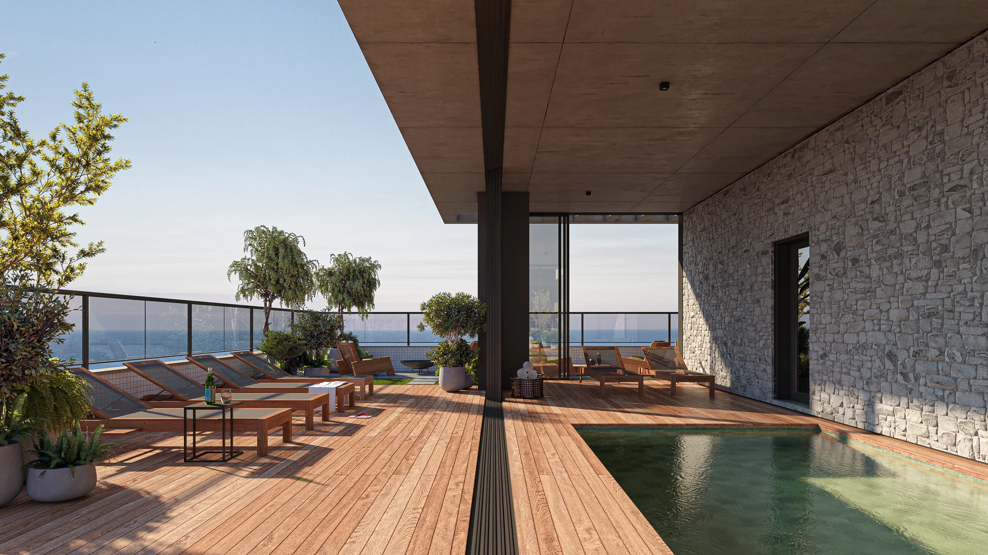 Deck do rooftop do Cascais Soft Living com espreguiçadeiras, piscina e vista do mar