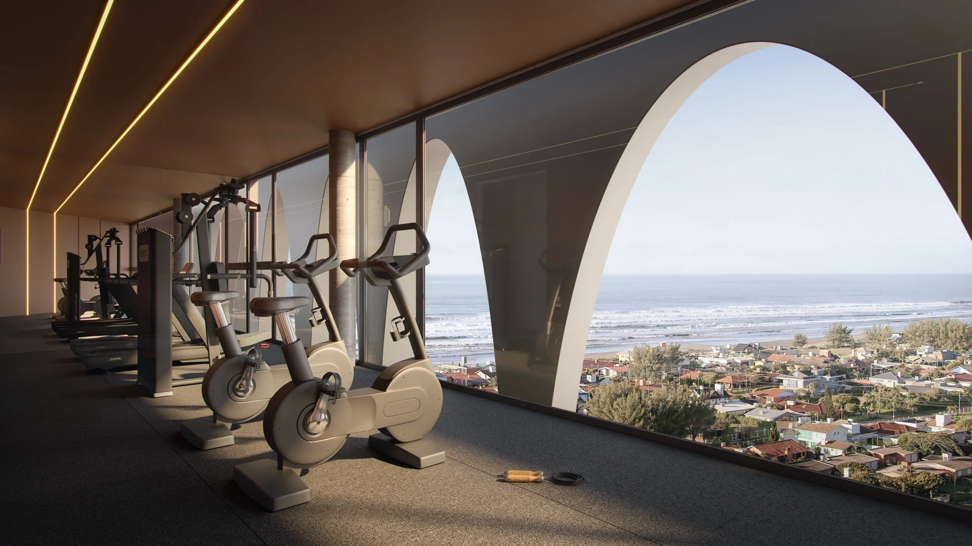 Espaço fitness do Doha Exclusive Living com o mar emoldurado pelos arcos do rooftop