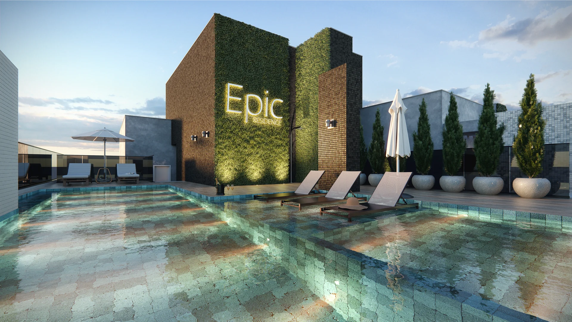 Rooftop do Epic Residence com piscina iluminada e o letreiro Epic sobre a parede verde viva, no topo da torre em Capão da Canoa