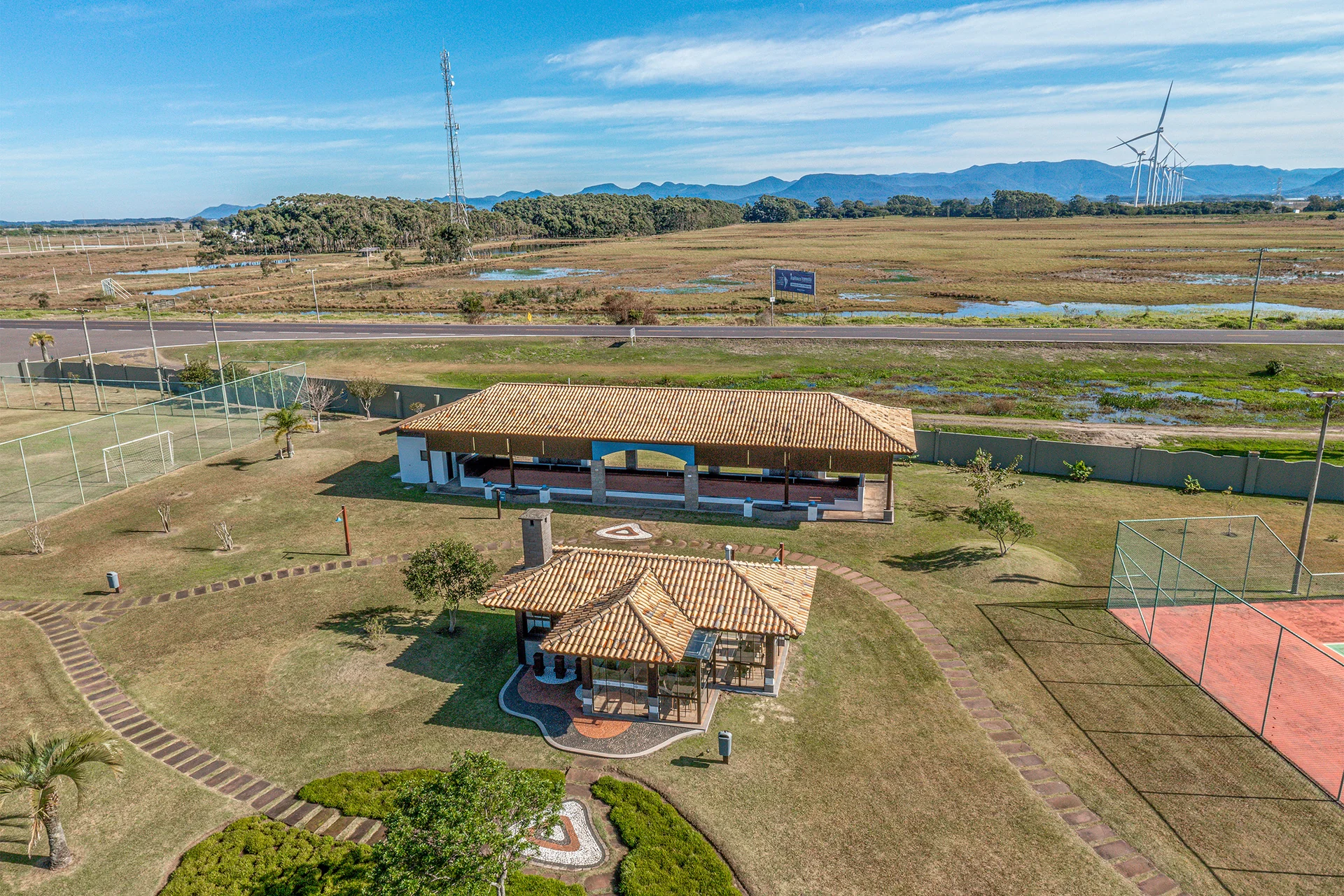 Foto aérea do pavilhão de churrasqueira e do salão de festas telhado colonial do Quintas do Lago, junto às quadras
