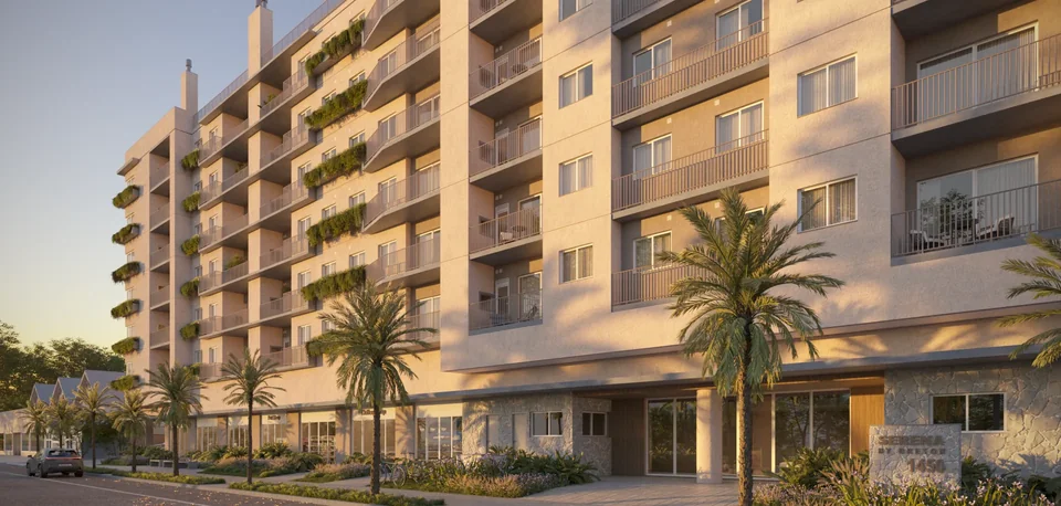 Render da fachada do Serena by Breton na Avenida Central, 1450, em Atlântida, com sacadas ajardinadas, palmeiras na calçada e luz de fim de tarde
