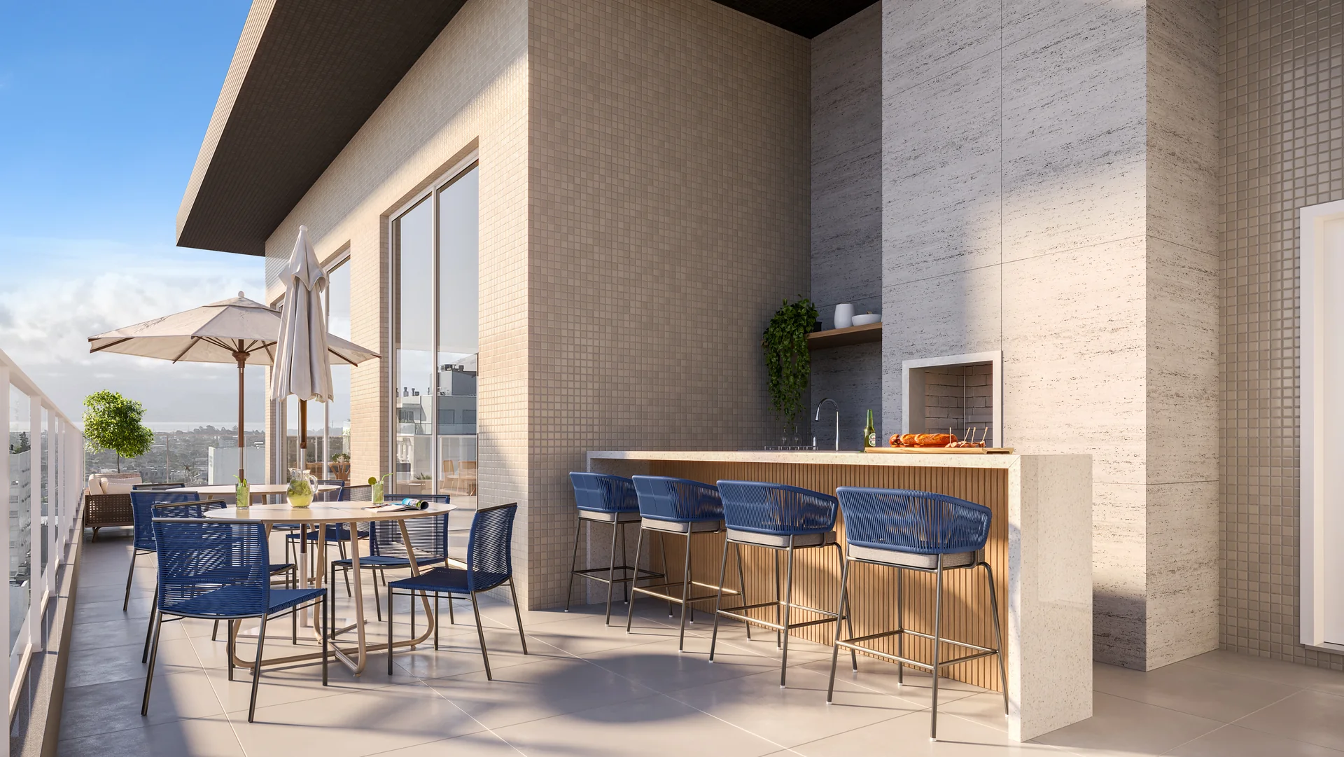 Gourmet externo no rooftop do Vivaz Residence, com bancada, banquetas e área coberta ao lado do deck da piscina
